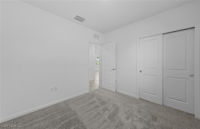 unfurnished bedroom featuring a closet and carpet