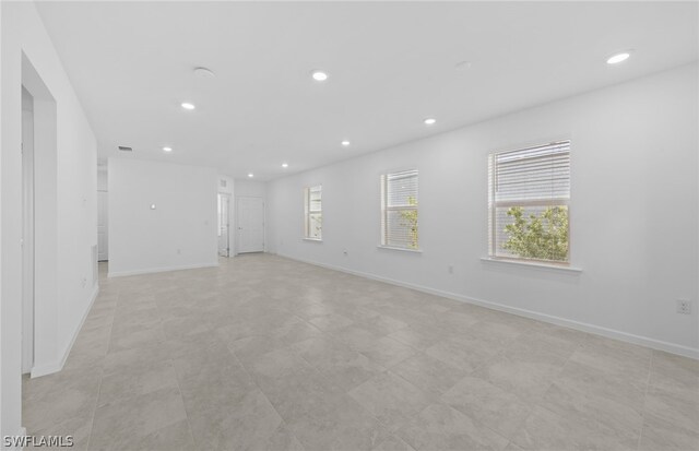 unfurnished room with light tile flooring