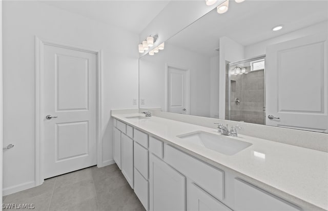 bathroom with double sink vanity, tile floors, and tiled shower