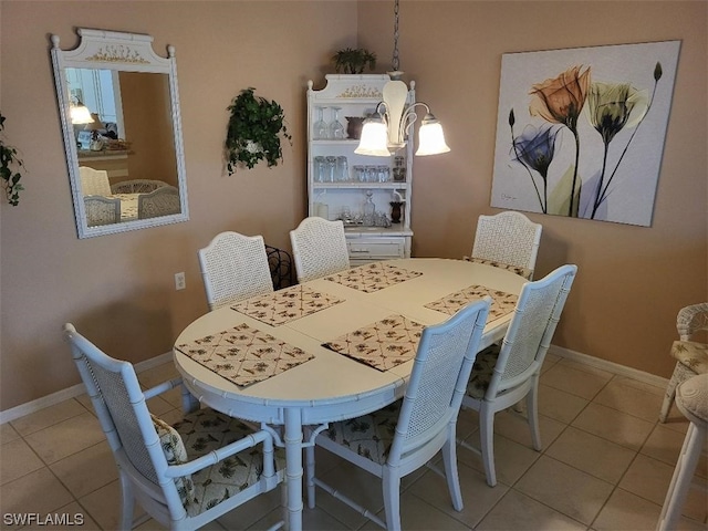 tiled dining area featuring a notable chandelier