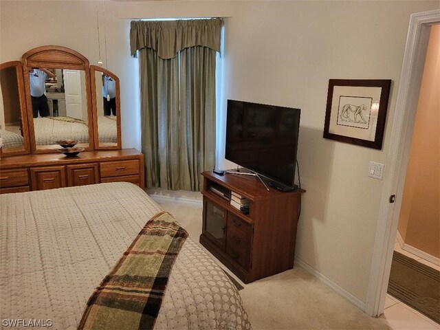 bedroom featuring light carpet