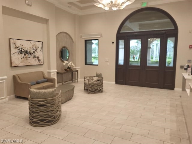 foyer with a chandelier and light tile floors