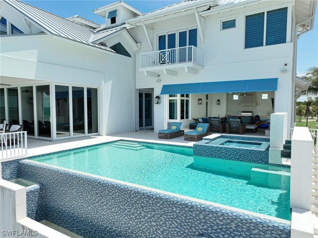 view of swimming pool featuring an outdoor living space, an in ground hot tub, and a patio area