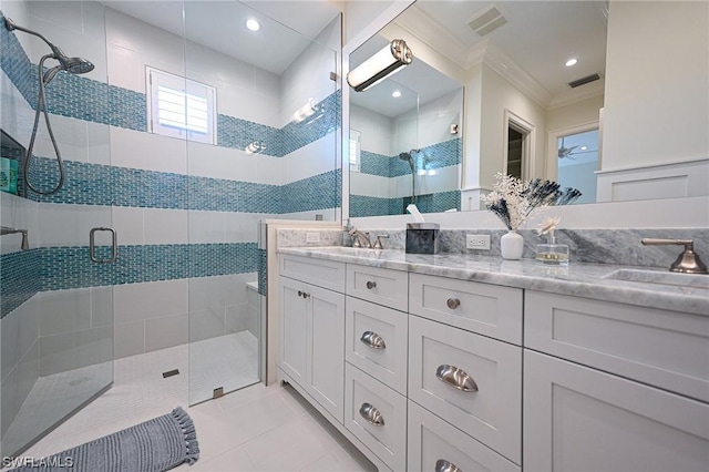 bathroom with vanity, crown molding, tile patterned floors, and walk in shower