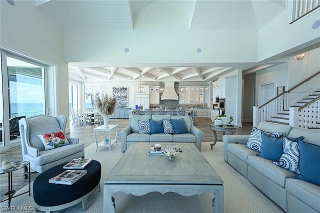 living room with coffered ceiling, beam ceiling, and a high ceiling