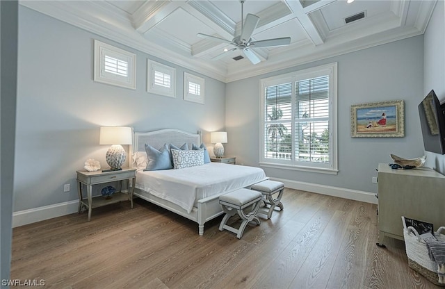 bedroom featuring beam ceiling, wood-type flooring, coffered ceiling, and ornamental molding