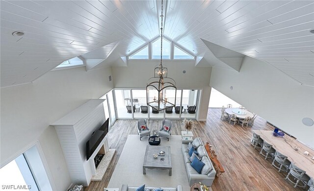 living room with wood ceiling, wood-type flooring, a chandelier, and high vaulted ceiling