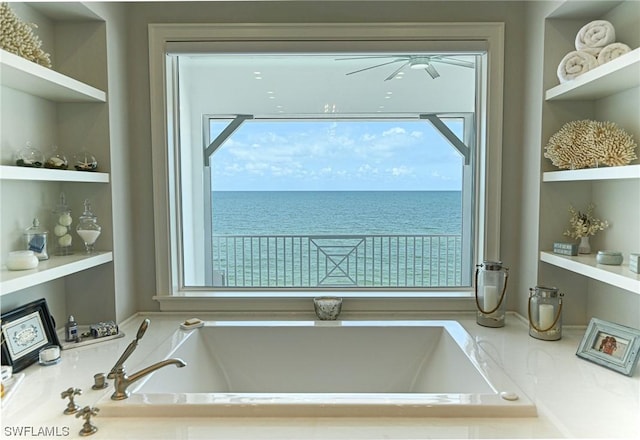 bathroom featuring a water view and built in features