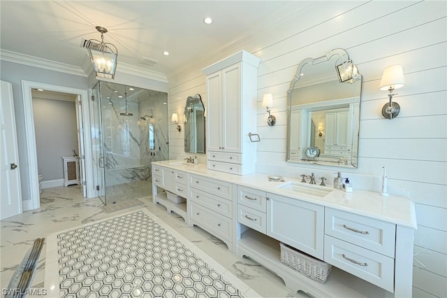 bathroom with vanity, a shower with shower door, and ornamental molding