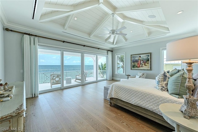 bedroom featuring hardwood / wood-style flooring, vaulted ceiling with beams, a water view, ornamental molding, and access to outside