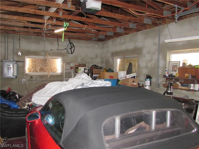 garage featuring a garage door opener and electric panel