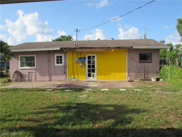 rear view of house with a yard and a patio