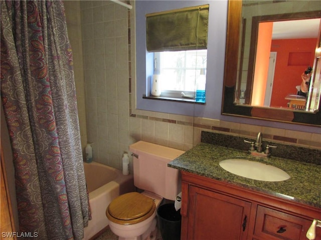 full bathroom featuring vanity, toilet, tile walls, and shower / bath combo