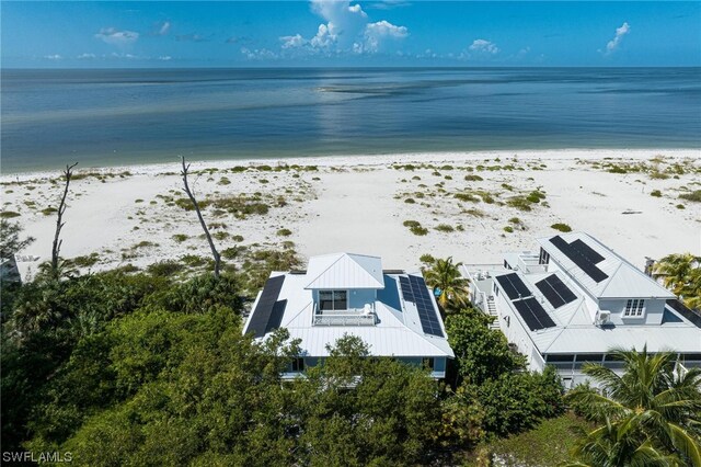 drone / aerial view featuring a view of the beach and a water view