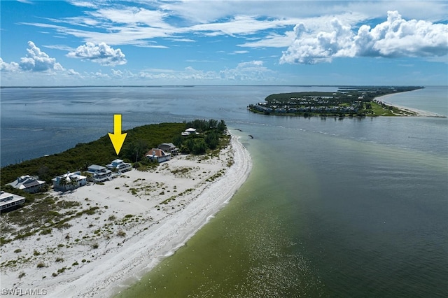 birds eye view of property featuring a beach view and a water view