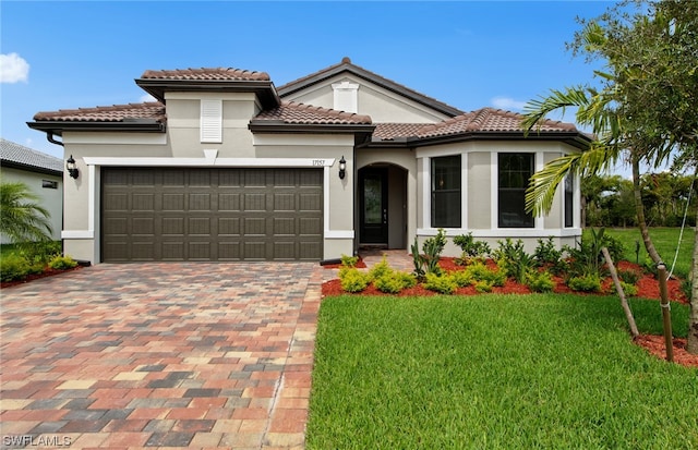 mediterranean / spanish house featuring a front yard and a garage