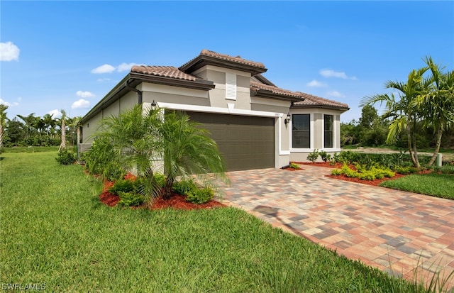 mediterranean / spanish-style home with a front lawn and a garage