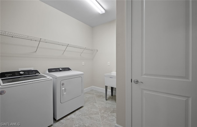 laundry room featuring light tile floors and washing machine and dryer