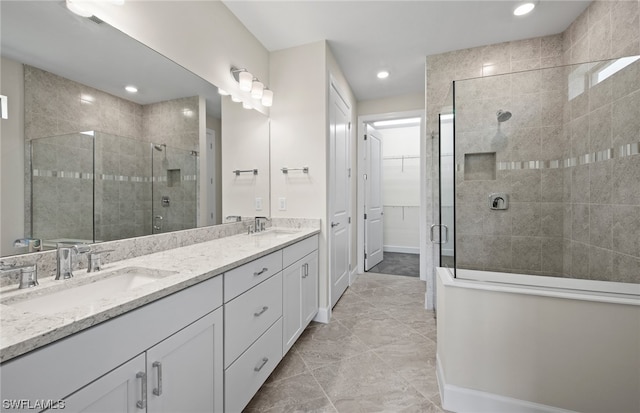 bathroom with tile flooring, dual vanity, and a shower with shower door