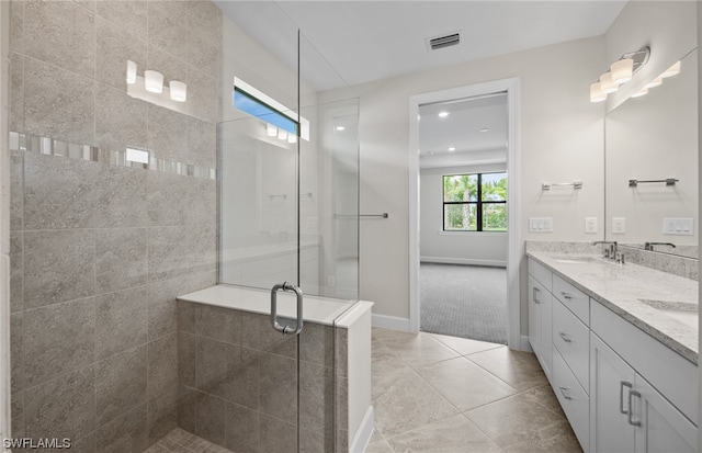 bathroom featuring double vanity, tile flooring, and a shower with shower door