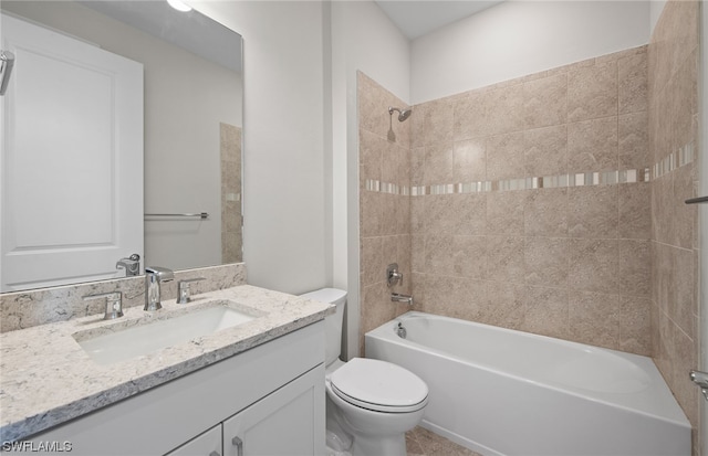 full bathroom with vanity with extensive cabinet space, toilet, and tiled shower / bath