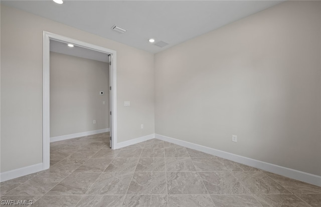 unfurnished room with light tile floors