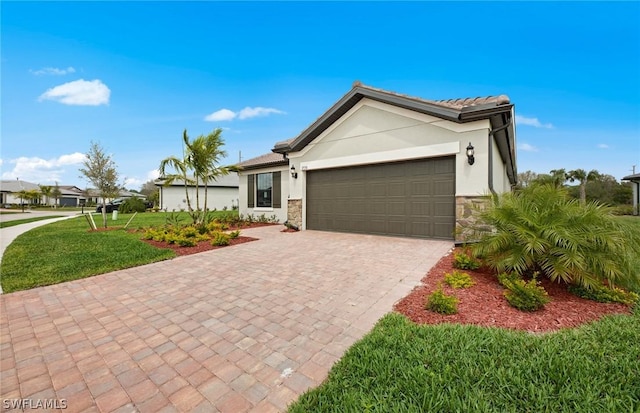 view of front of property with a garage and a front lawn