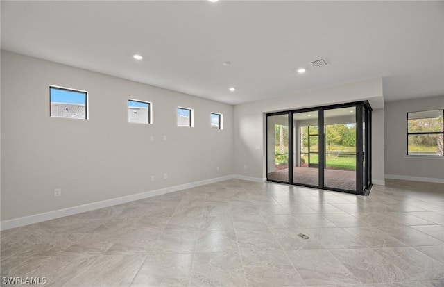 unfurnished room featuring plenty of natural light