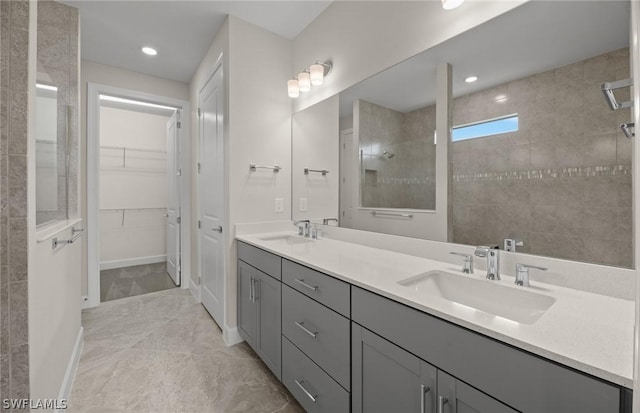 bathroom with vanity and tiled shower