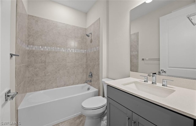 full bathroom with vanity, tiled shower / bath combo, and toilet