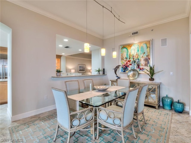 dining area featuring crown molding