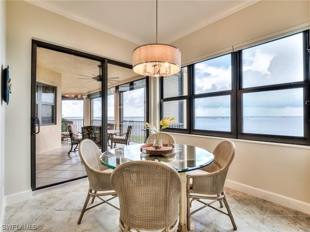 dining room with crown molding, plenty of natural light, and ceiling fan