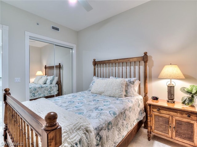 carpeted bedroom featuring ceiling fan and a closet