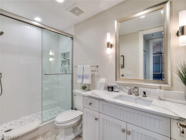 bathroom with vanity, toilet, and walk in shower