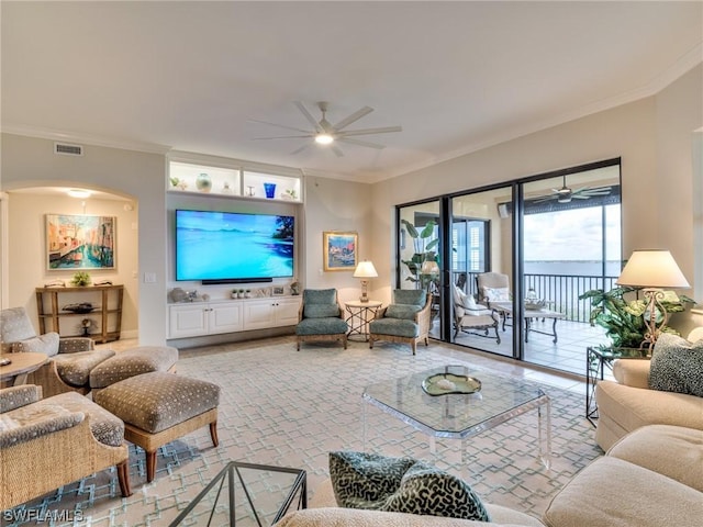 living room with ornamental molding and ceiling fan