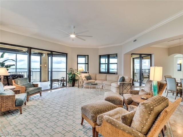 living room with ornamental molding and ceiling fan