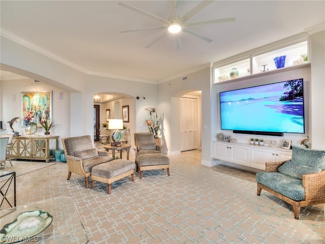 living room with ornamental molding and ceiling fan