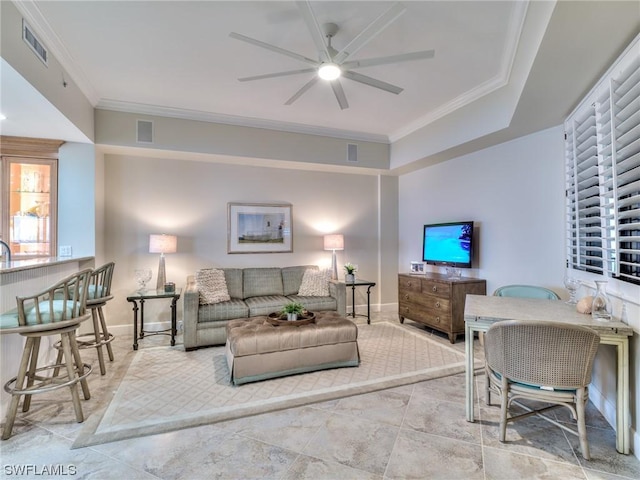 living room featuring ceiling fan and ornamental molding