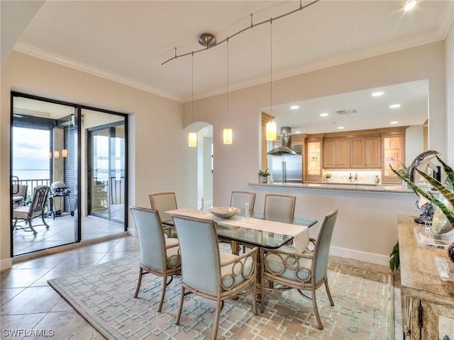 dining room featuring ornamental molding and light tile patterned floors