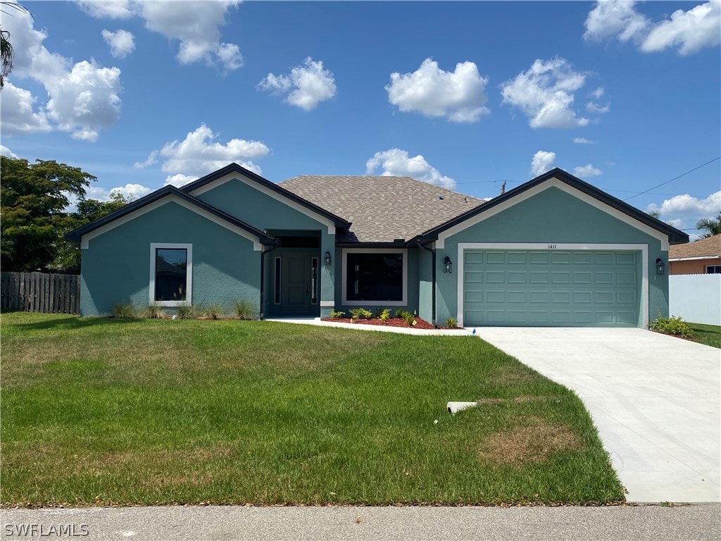 ranch-style home featuring a garage and a front lawn