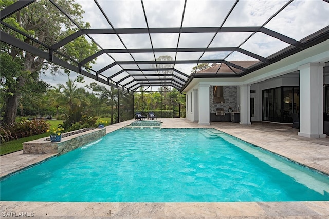 outdoor pool featuring glass enclosure and a patio