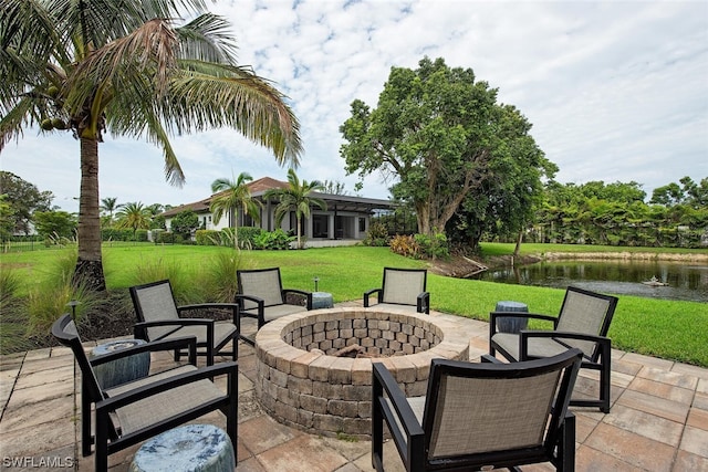 view of patio featuring a water view and an outdoor fire pit