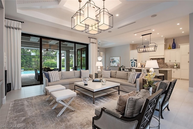 living area with an inviting chandelier, light tile patterned floors, and recessed lighting
