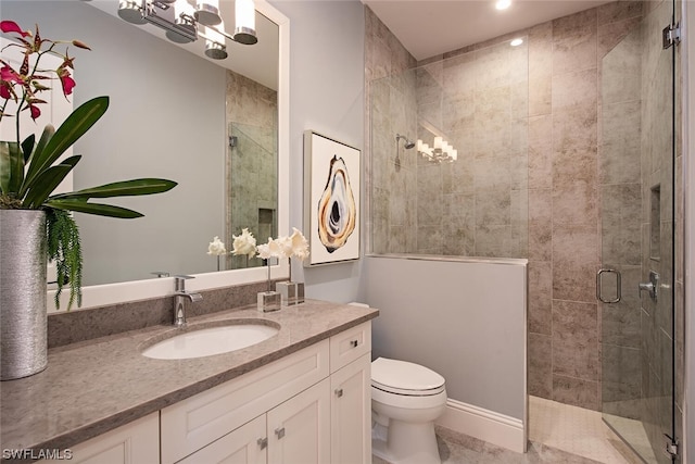 bathroom with a stall shower, toilet, and vanity