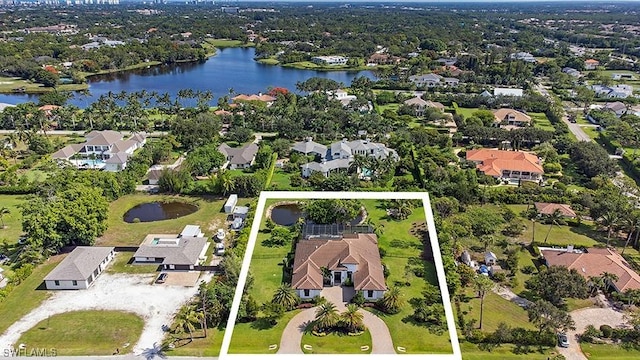 bird's eye view featuring a water view and a residential view