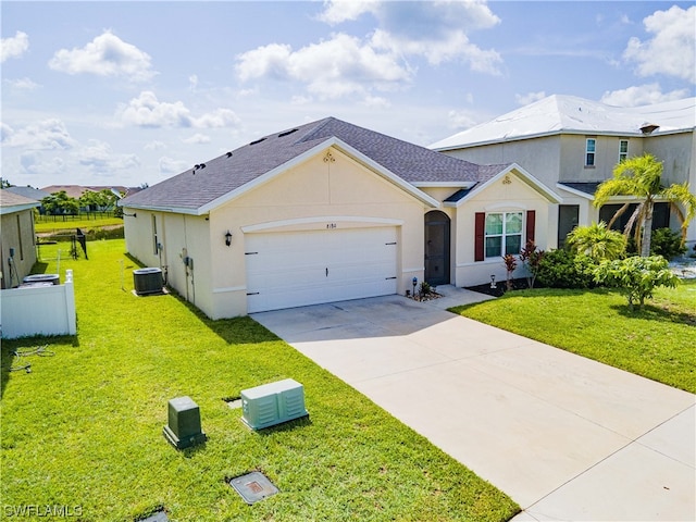 view of front of home featuring a front yard, a garage, and central AC unit