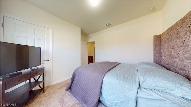 bedroom with light carpet and vaulted ceiling