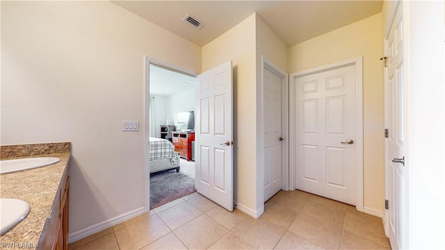 bathroom featuring tile flooring and vanity