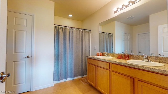 bathroom with double sink vanity and tile floors