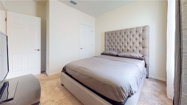 bedroom featuring light colored carpet